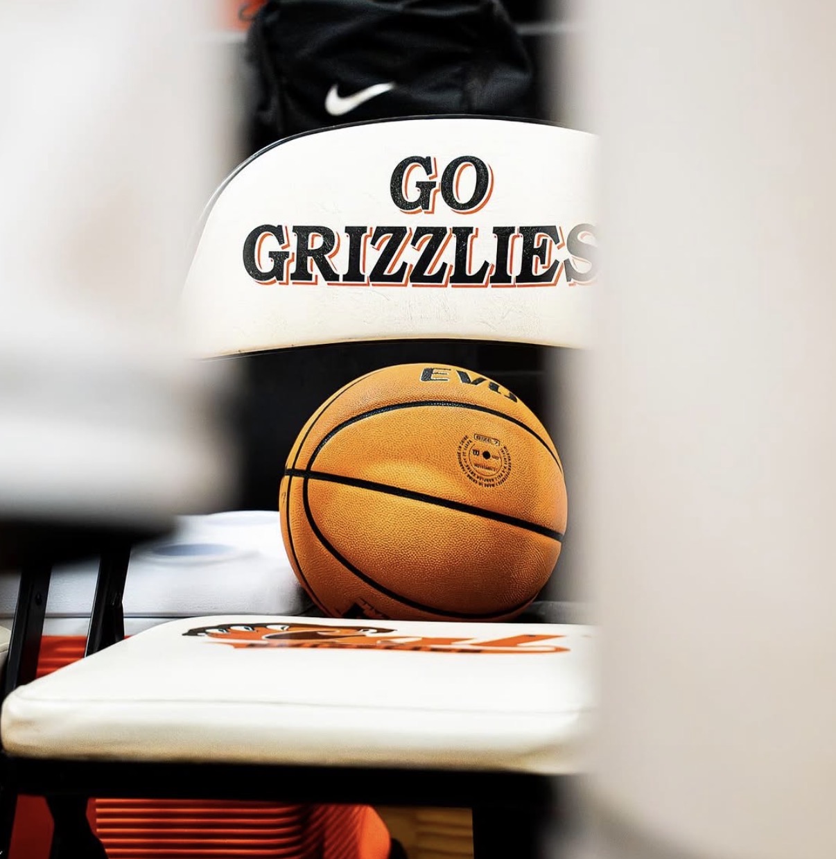 Basketball resting on a Cal High Grizzlies courtside chair with GO GRIZZLIES text